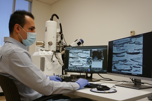 Mohsen Hosseini views the images produced by the JEOL IT500 scanning electron microscope, located in the Nanoscale Characterization and Fabrication Laboratory