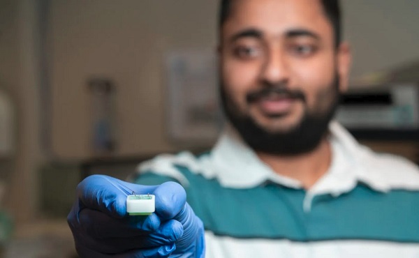 PhD researcher Shankar Dutt holding the ANU-developed technology, which isolates proteins from other biomolecules in our blood to search for signs of early neurodegeneration.