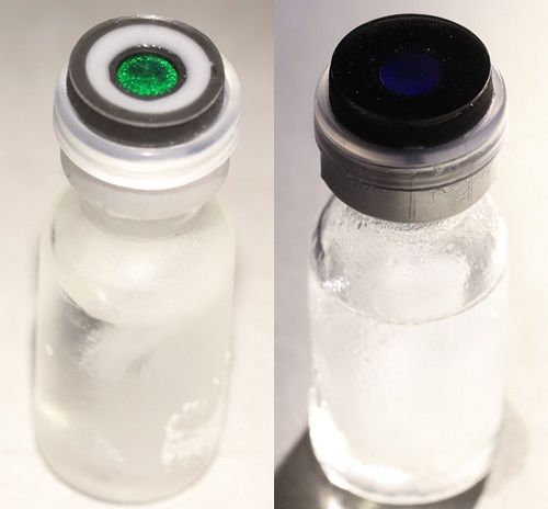Appearing green on a vial lid (left), this structural color material becomes colorless (right) when warmed.