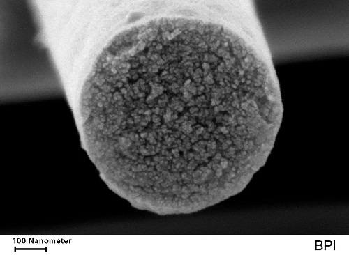 Scanning electron image of a cross-section of a fiber containing a matrix of carbon in which nano-sized ceramic phases are distributed.