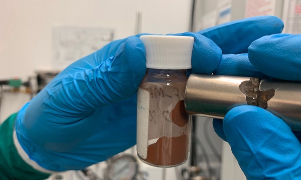 A magnet attracts the material that the team used to make adsorbents that remove microplastics and dissolved pollutants from water